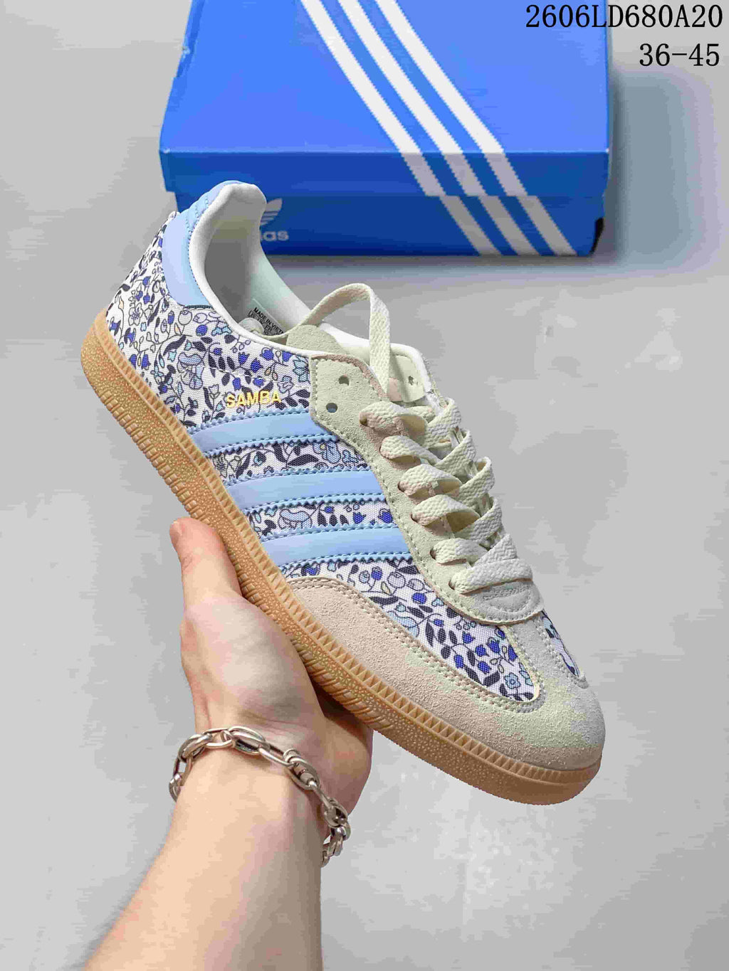Blue floral-print low-top sneaker with pale blue stripes and a gum-look sole