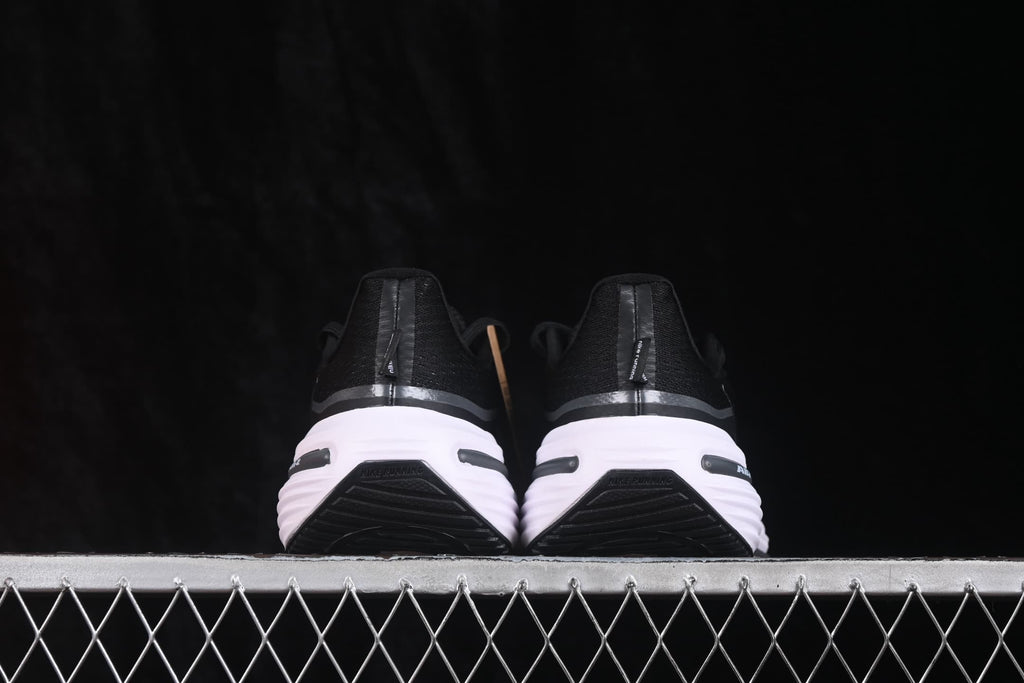 Rear view of the pair showing black heel sections, white midsoles and black outsole details.