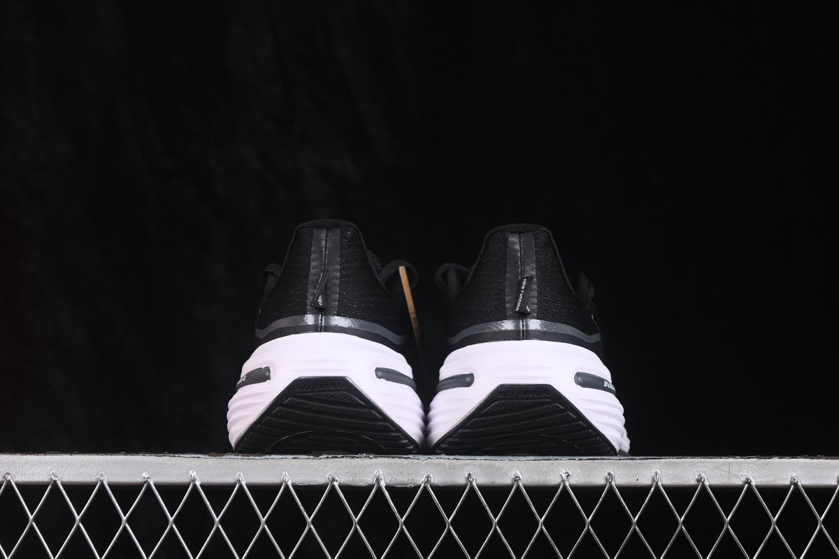 Rear view of the pair showing black heel sections, white midsoles and black outsole details.