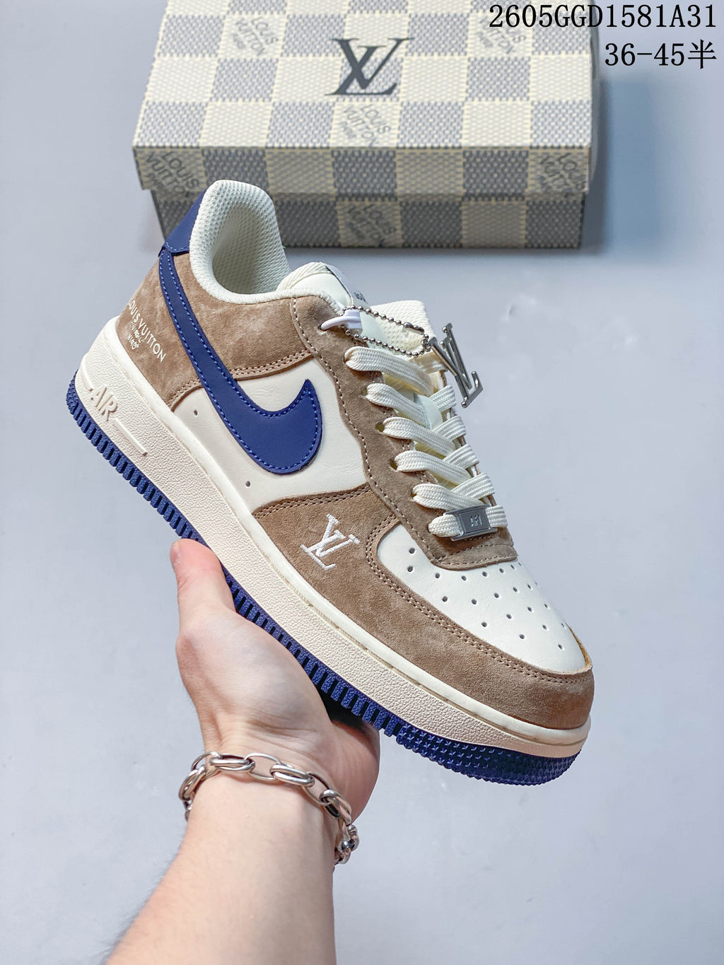 Angled view of a cream and taupe low-top sneaker with blue accents
