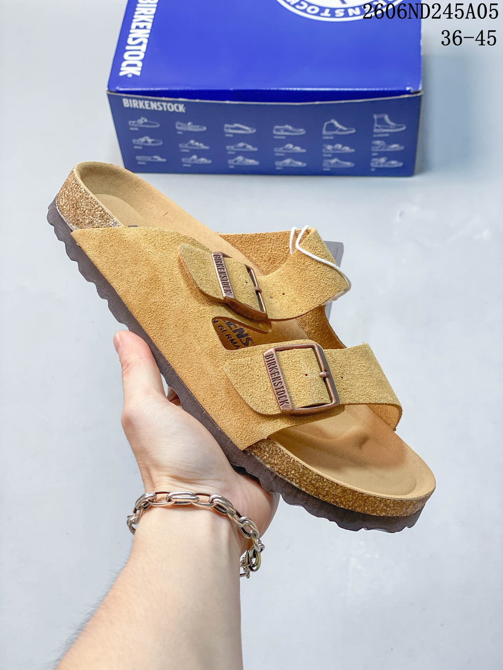 Tan two-strap sandal with buckle closures and contoured footbed.