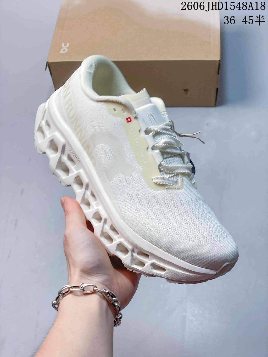 Angled side view of a white sneaker with a knit-look upper and sculpted sole