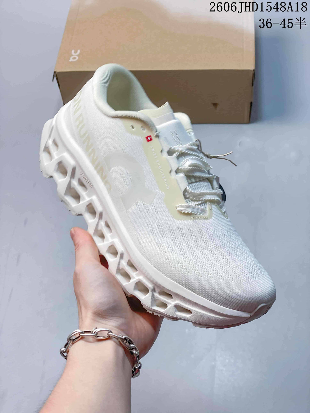 Angled side view of a white sneaker with a knit-look upper and sculpted sole