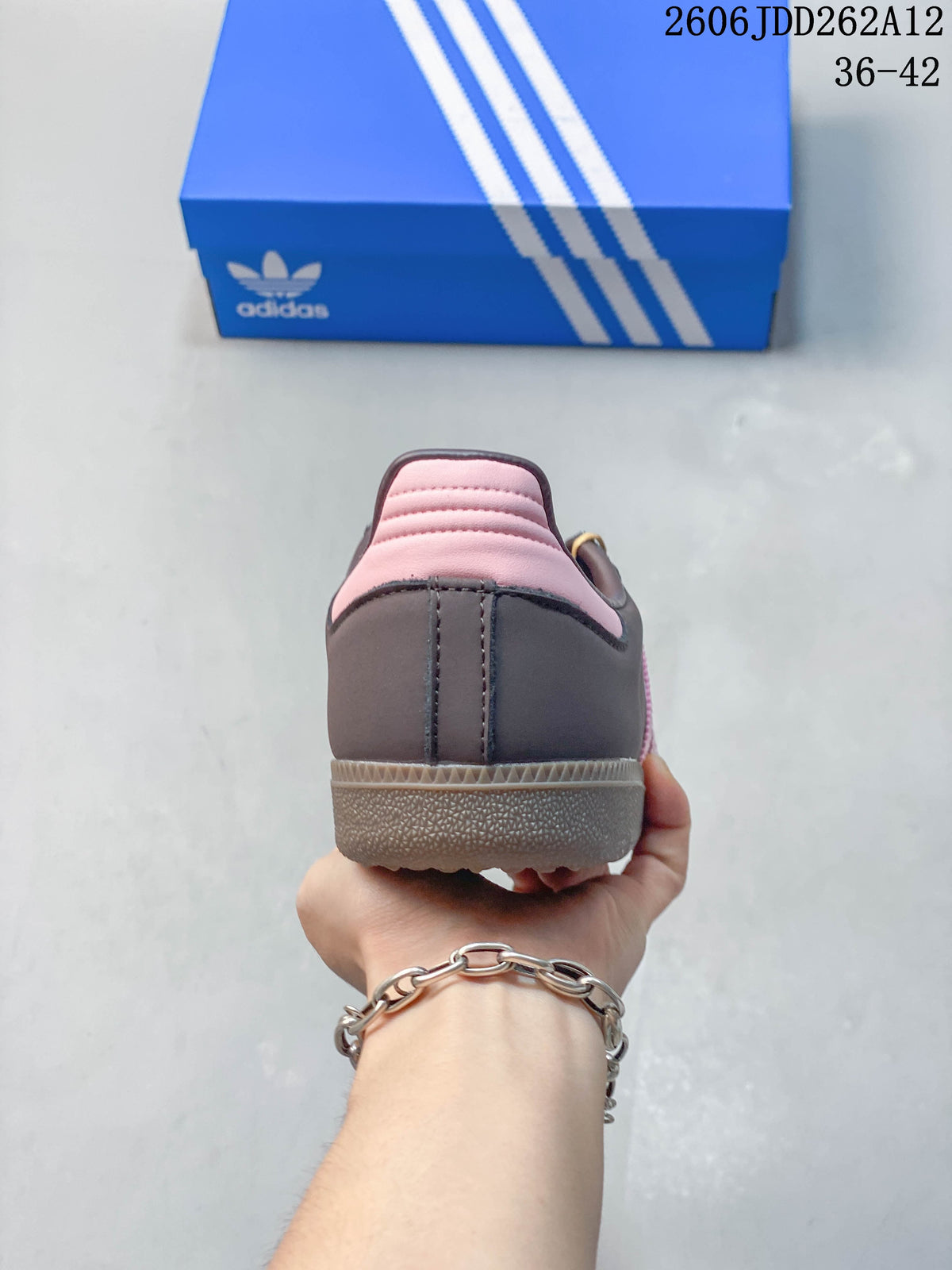 Rear view showing pink heel panels and a grey heel counter.