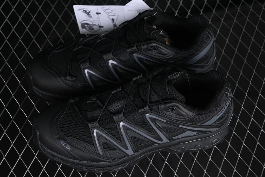 Pair of black XT-Quest shoes photographed from above at an angle.