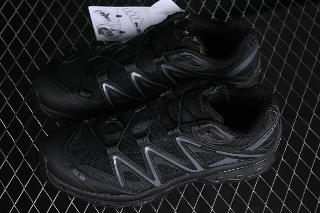 Pair of black XT-Quest shoes photographed from above at an angle.