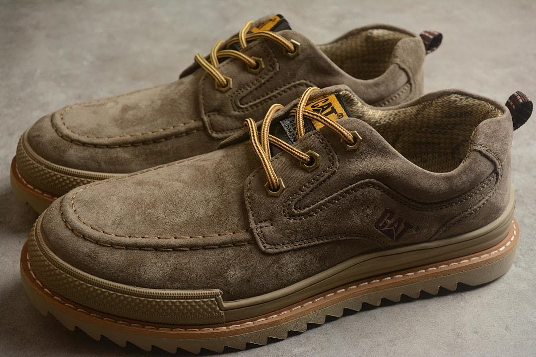 Pair of taupe-brown CAT low-top lace-up shoes