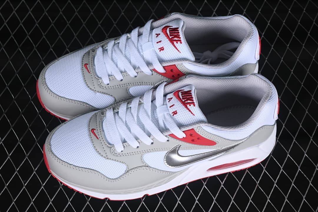 Pair of white, grey, and red sneakers shown from above at an angle.