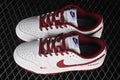 Pair of white and deep red Nike SB Dunk Low sneakers shown from above