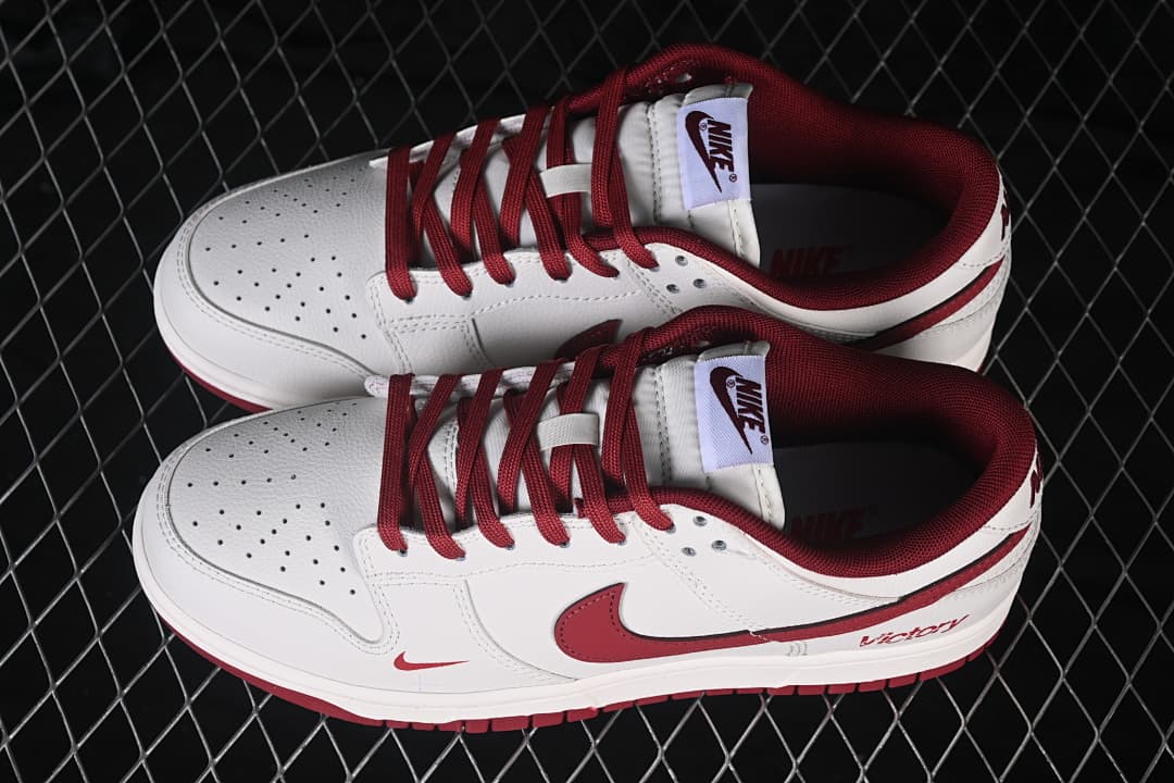 Pair of white and deep red Nike SB Dunk Low sneakers shown from above