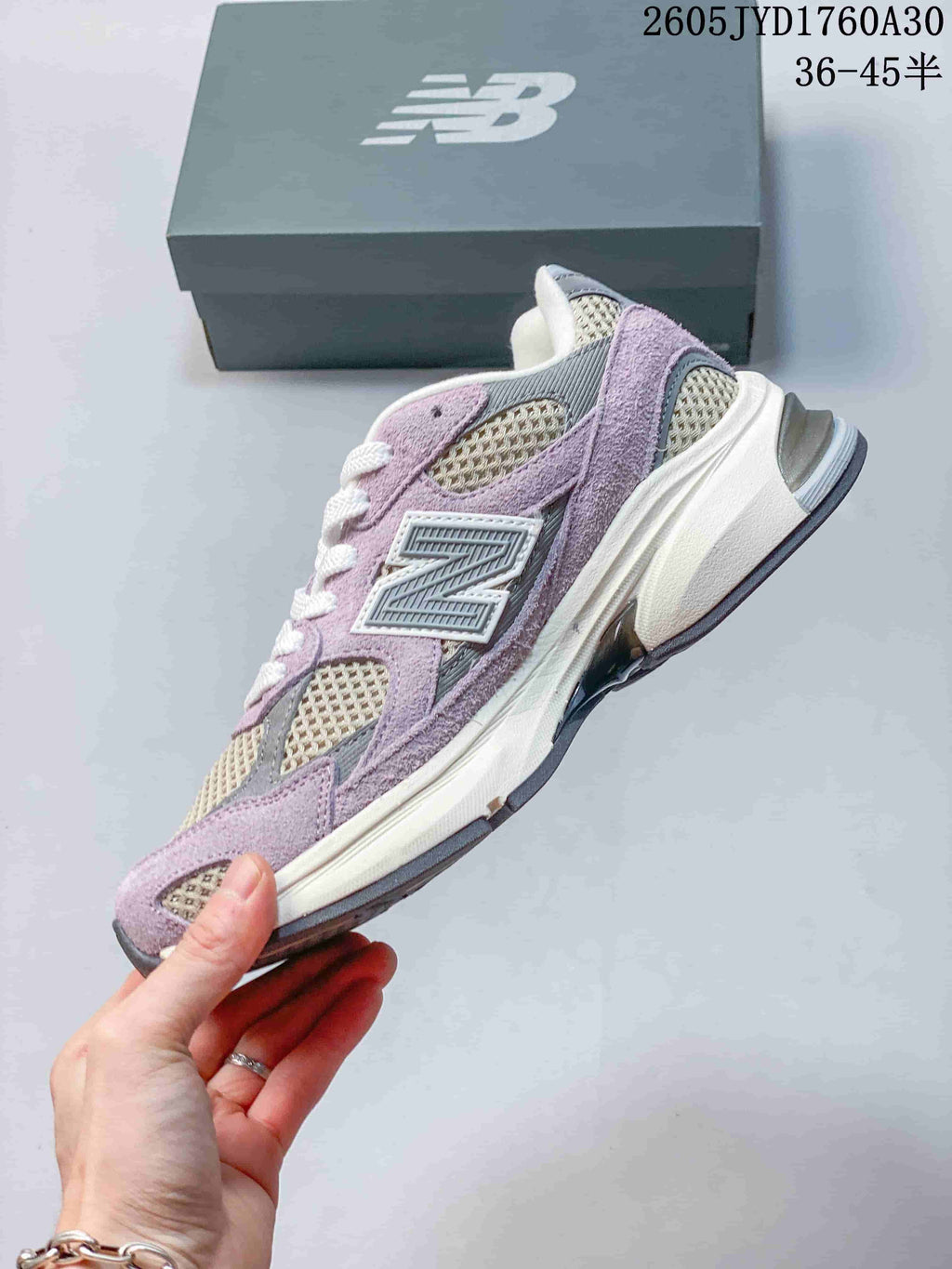 Side profile of a lavender, grey, and cream New Balance 2010 sneaker.