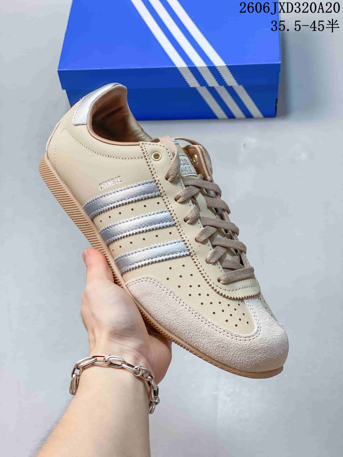 Angled side view of the beige and silver adidas Originals Japan sneaker