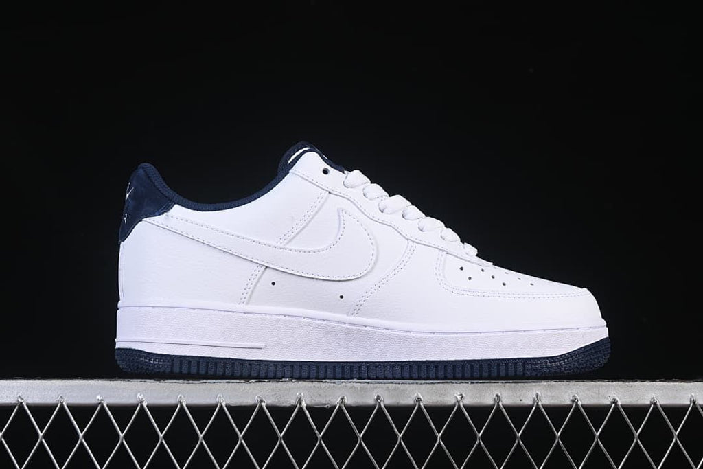 Side profile of a white and navy low-top sneaker