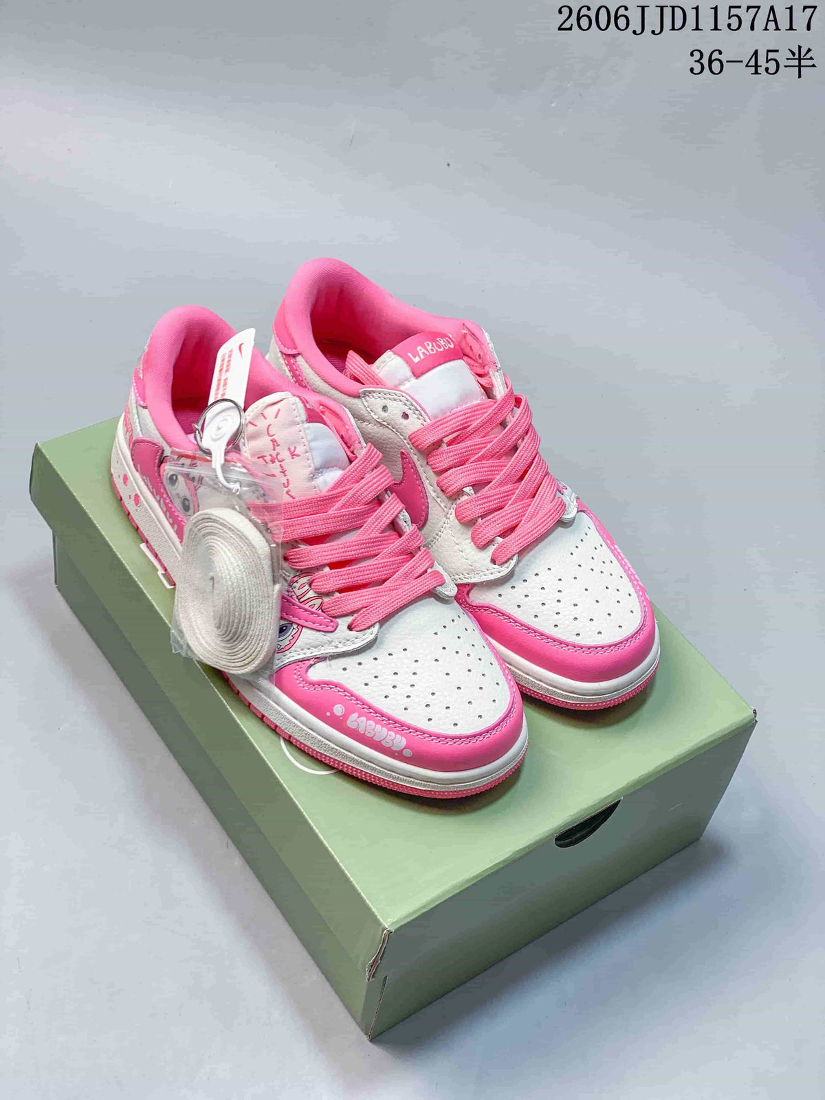 White and pink low-top sneakers with character graphics, pink laces, and an extra set of white laces