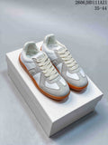 White and gray low-top lace-up sneakers with gum-colored soles