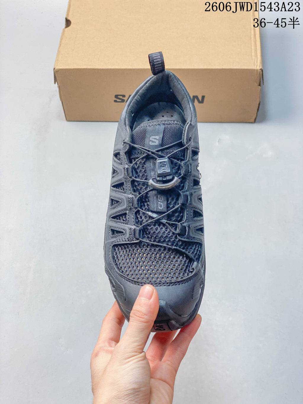 Top view showing the mesh upper and quick-lace system on a dark gray Salomon shoe.