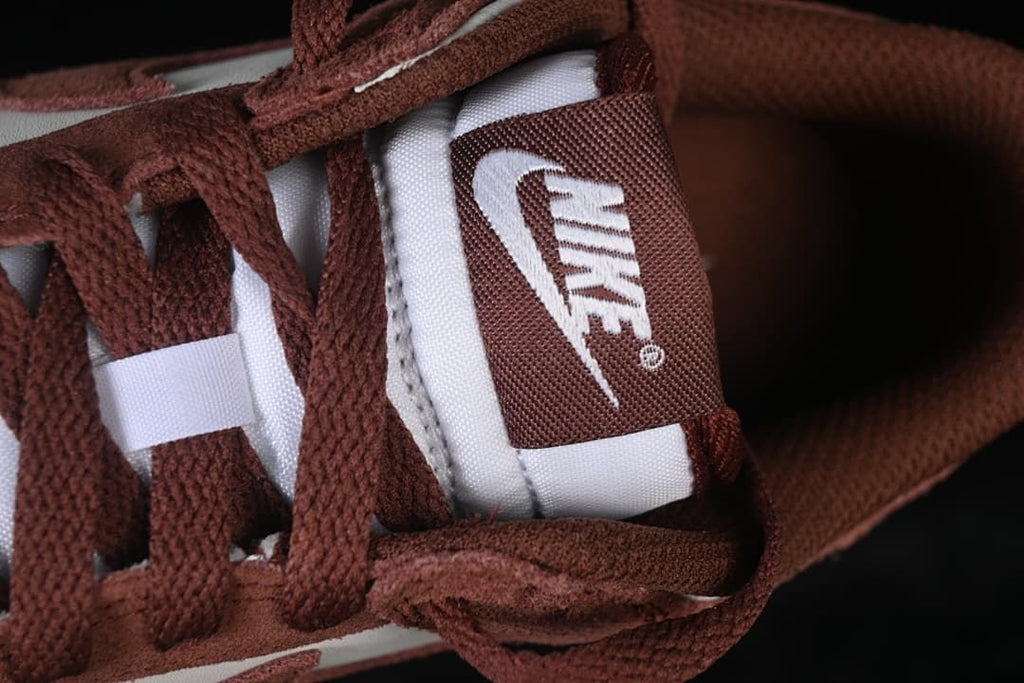 Close-up of brown laces and tongue label