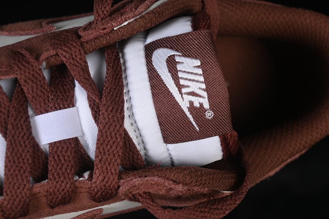 Close-up of brown laces and tongue label