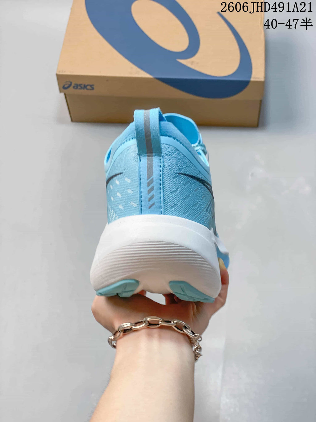 Rear view of a light blue ASICS running shoe