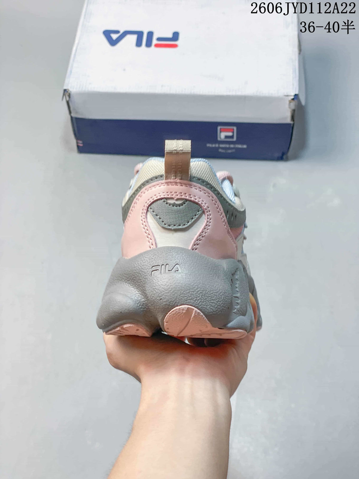 Rear view of a FILA FUSION Arceus sneaker showing the pink heel panels and sculpted grey sole.