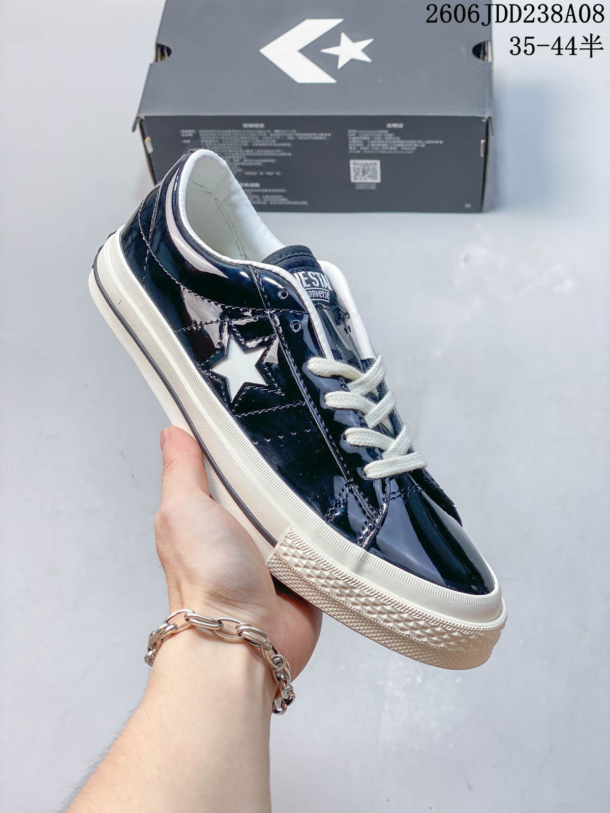 Angled side view of the glossy navy Converse One Star low-top sneaker.
