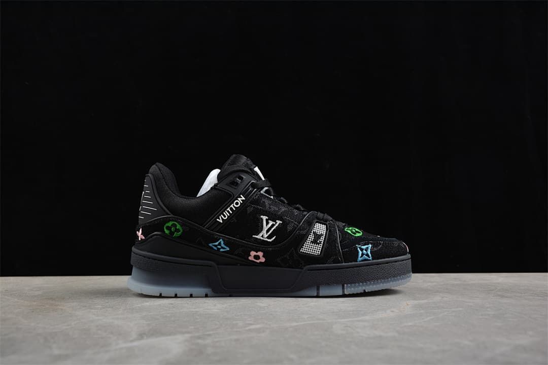 Side profile of the black sneaker with decorative motifs and pale outsole