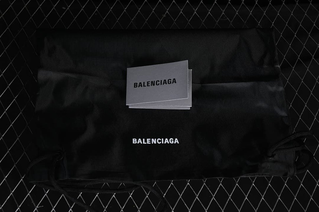 Black drawstring shoe bag and cards with Balenciaga branding.