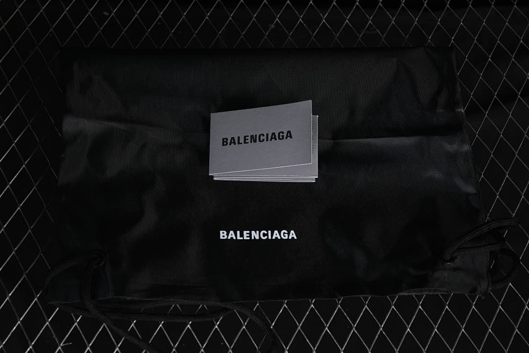 Black drawstring shoe bag and cards with Balenciaga branding.