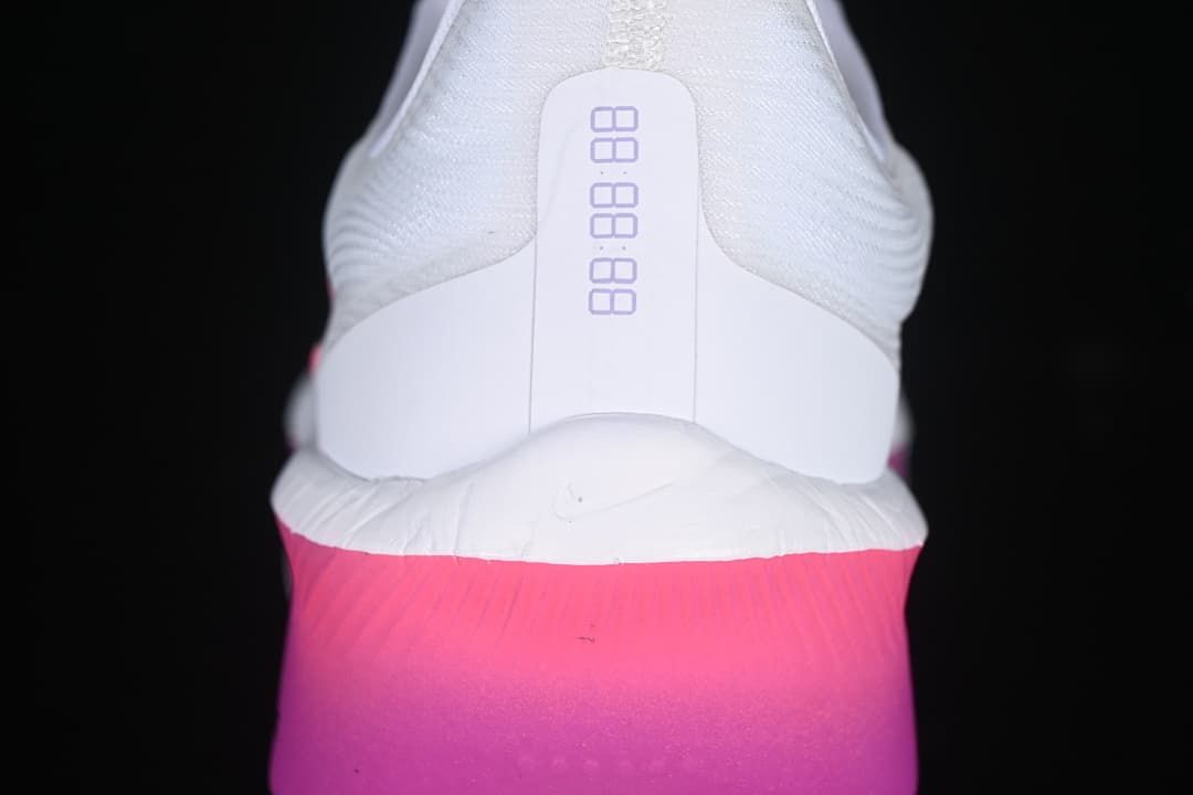 Rear view of shoe with white heel and bright pink-purple sole