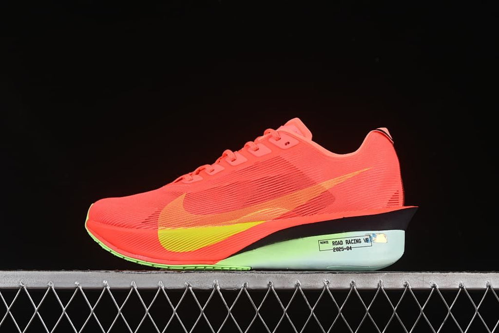 Side view of a coral-red Nike ZoomX Vaporfly NEXT% 4 with yellow accents and a pale mint-toned midsole.