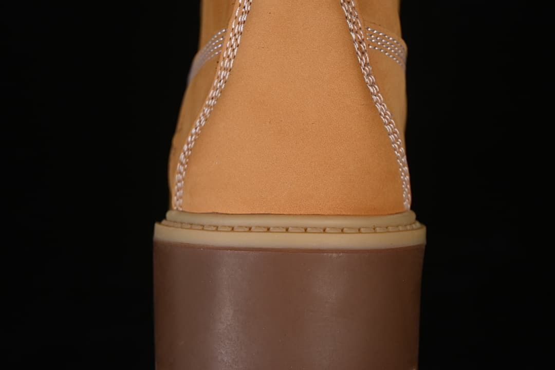 Rear view showing the boot's stitched heel and thick sole