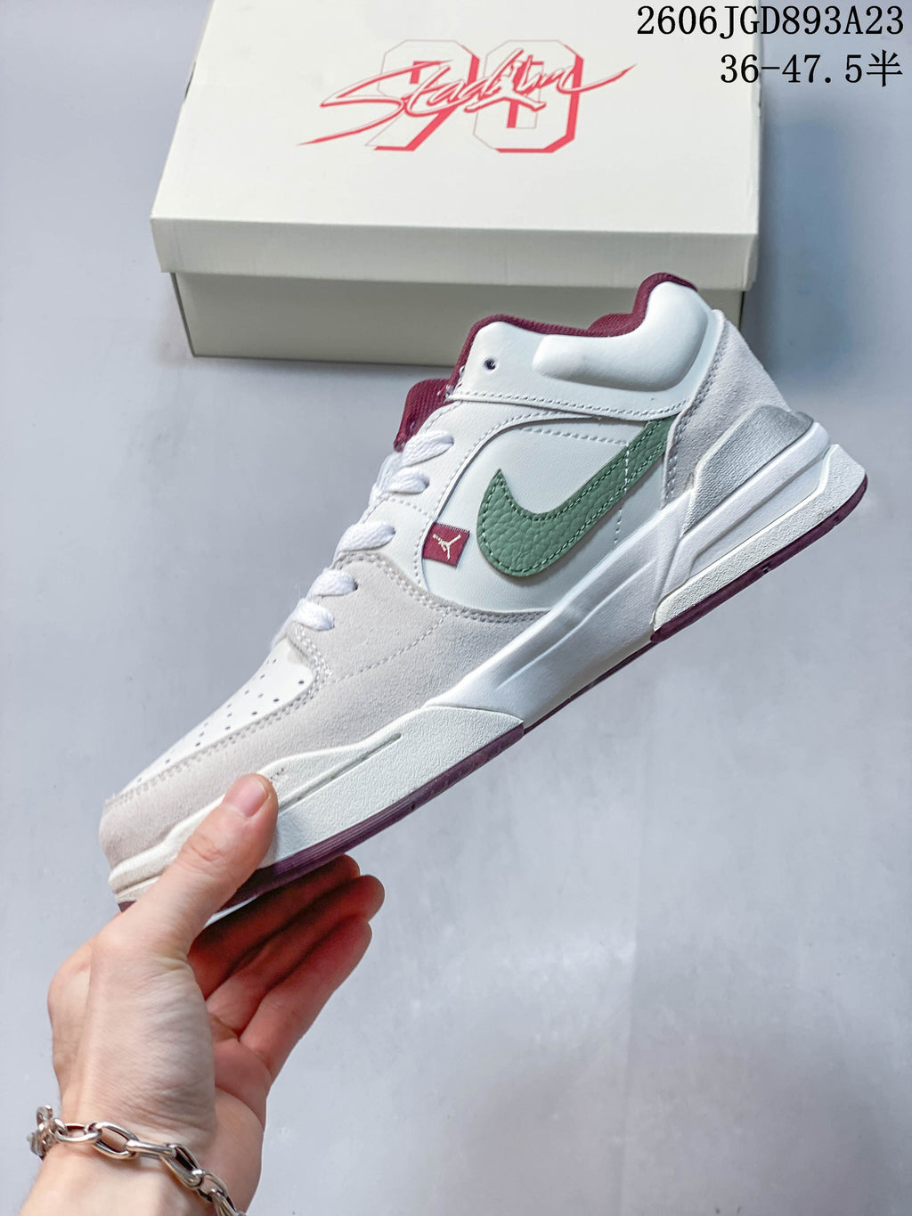 Side profile of the Jordan Stadium 90 with a green side logo and layered pale grey panels
