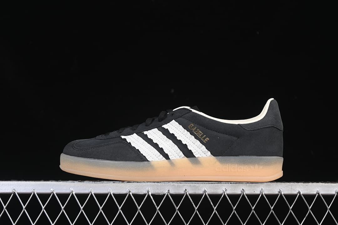 Side profile of the black Adidas Gazelle Indoor with white stripes and gum-colored outsole.
