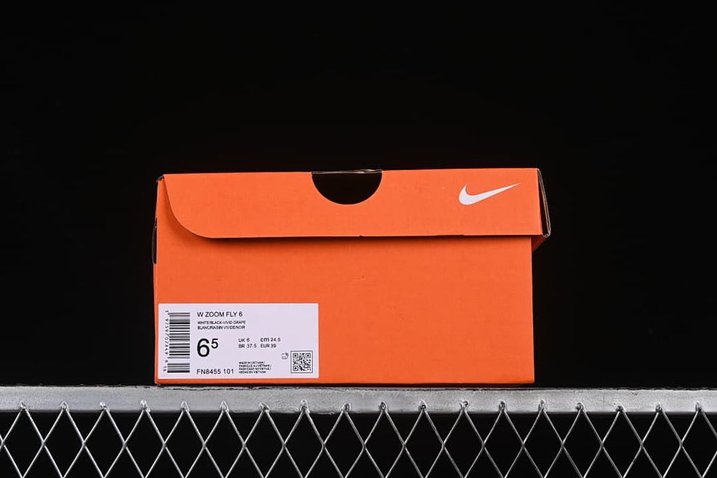 Orange Nike shoe box label showing Zoom Fly 6, color description, style code, and sample size