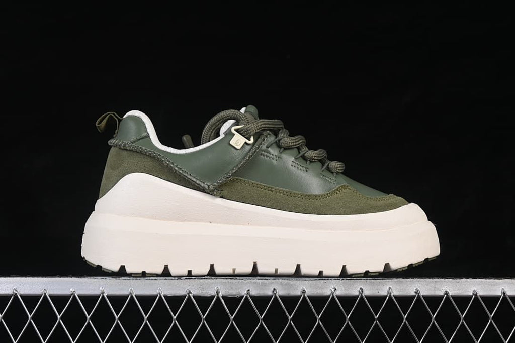 Side profile of the green sneaker with an oversized off-white sole