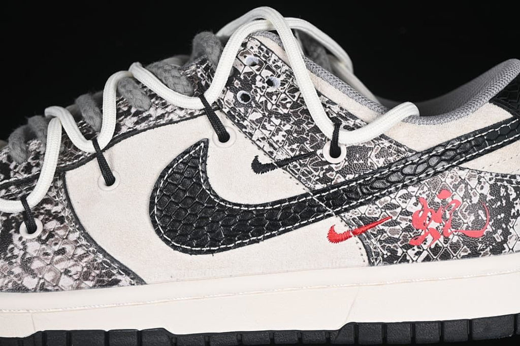 Close-up of the patterned overlays, textured black Swoosh, and red graphic accents
