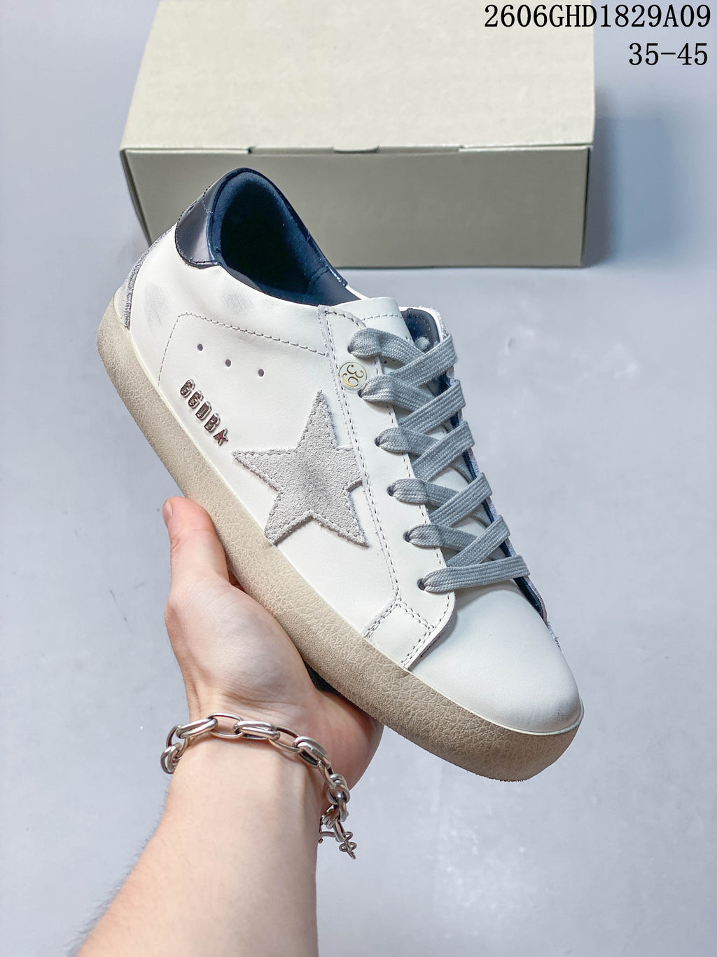 Side view showing the gray star detail, gray laces, and white upper