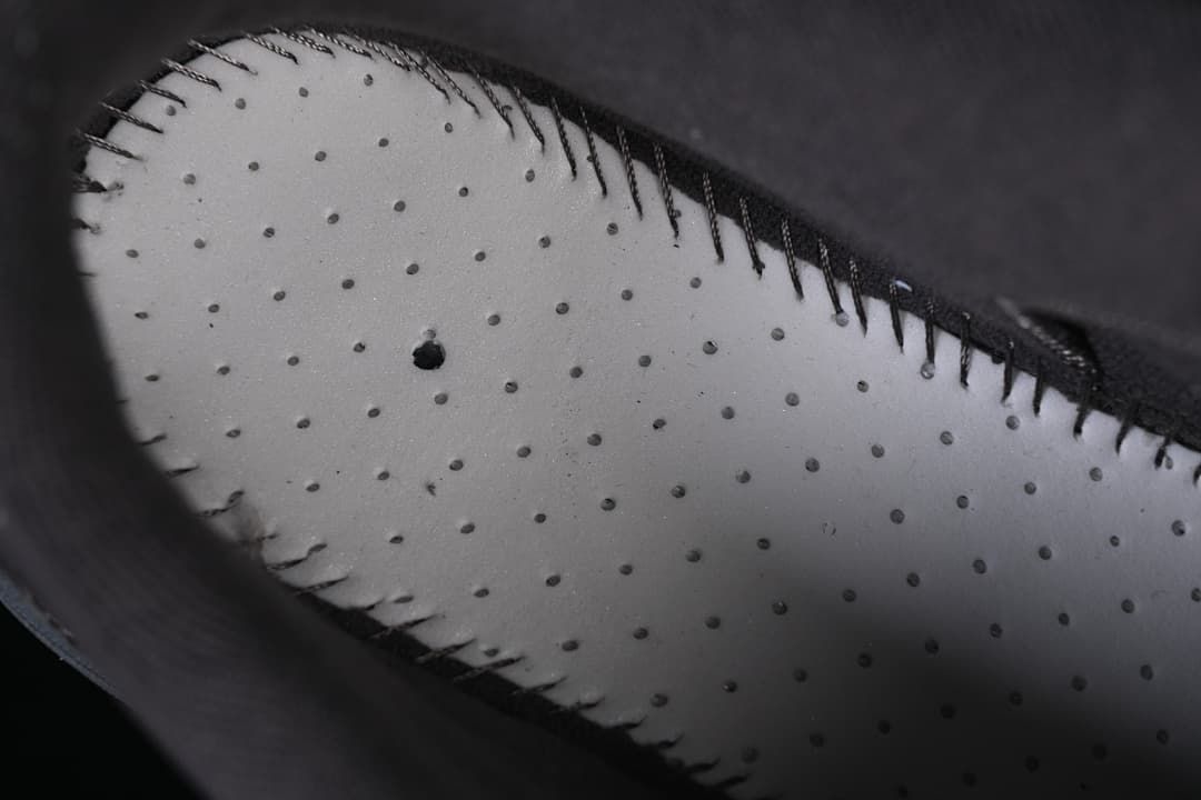 Close-up of perforated shoe interior and stitching