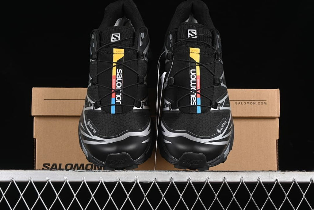 Front view of the pair of Salomon XT-6 GTX shoes in front of the box.