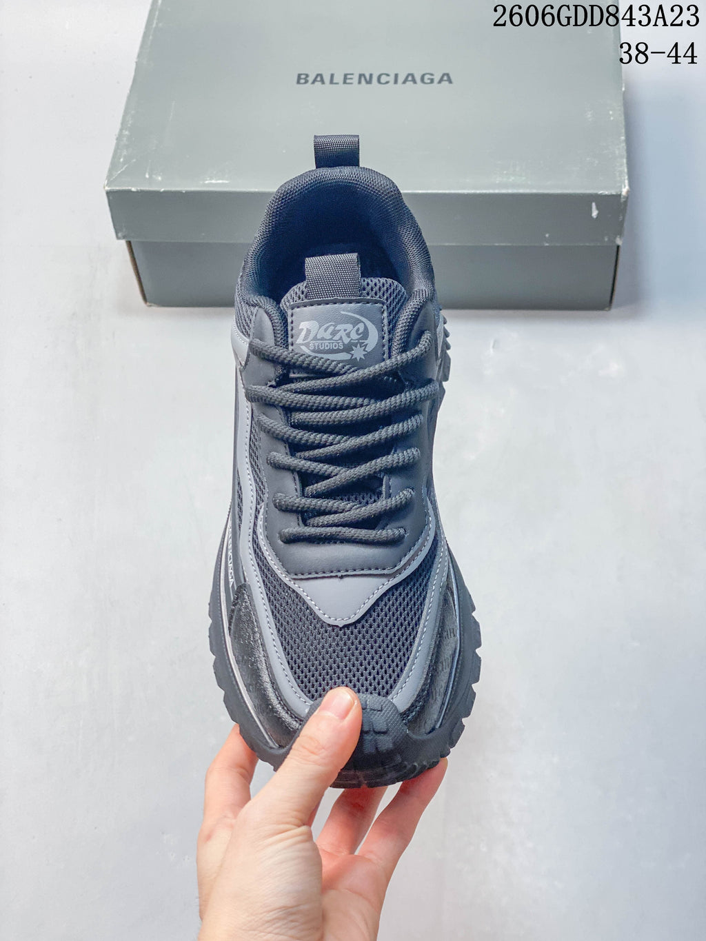 Front view showing the laces, mesh panel, and layered upper