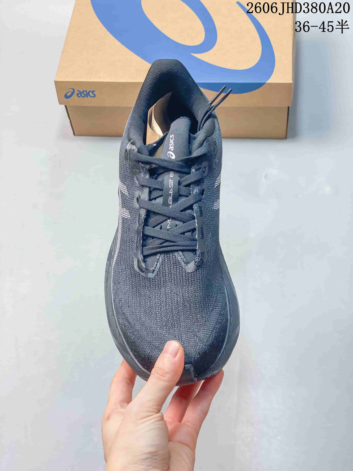 Front view of the dark charcoal running shoe showing the toe and laces