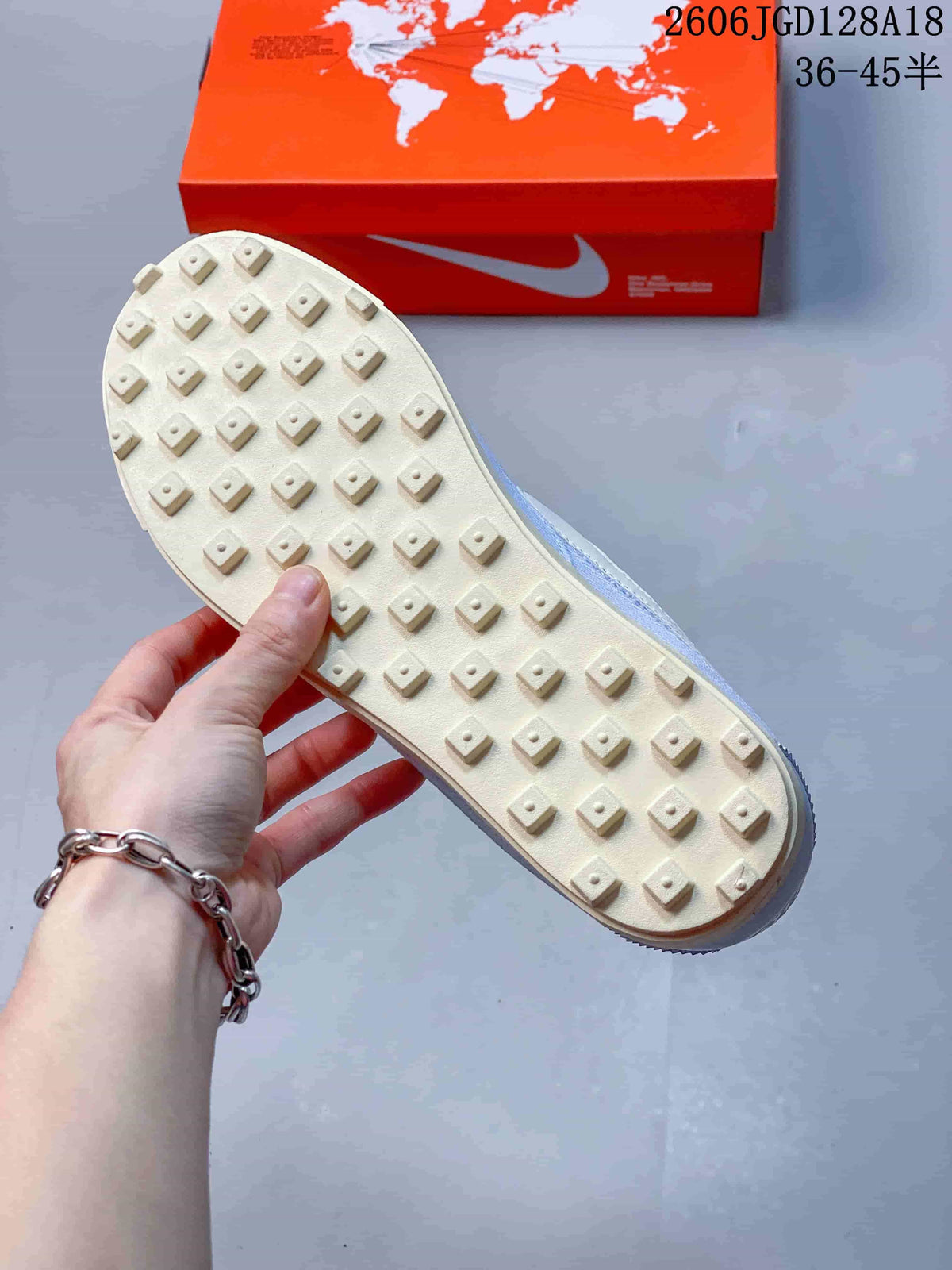Underside of a sneaker showing raised cream-colored tread