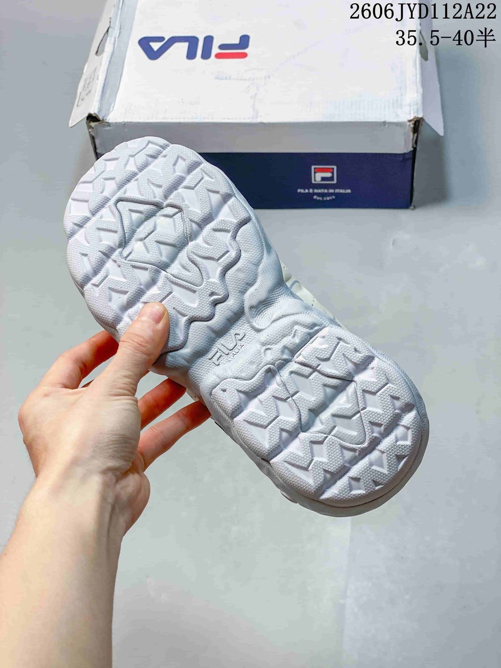 Close-up of the patterned outsole on a white FILA sneaker