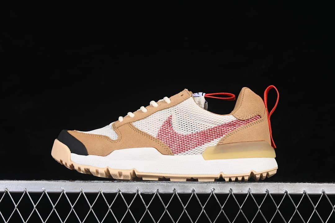 Side view of tan, white, and red NikeCraft Mars Yard sneakers against a dark background