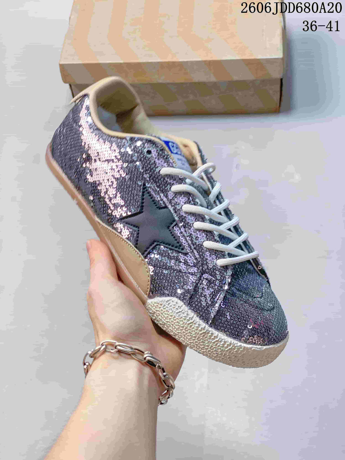 Angled view of the sequin sneaker showing its star detail and low-top profile
