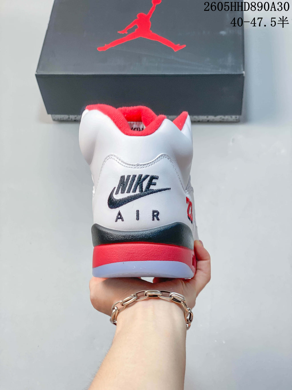 Rear view showing the heel branding and red, dark, and translucent outsole accents