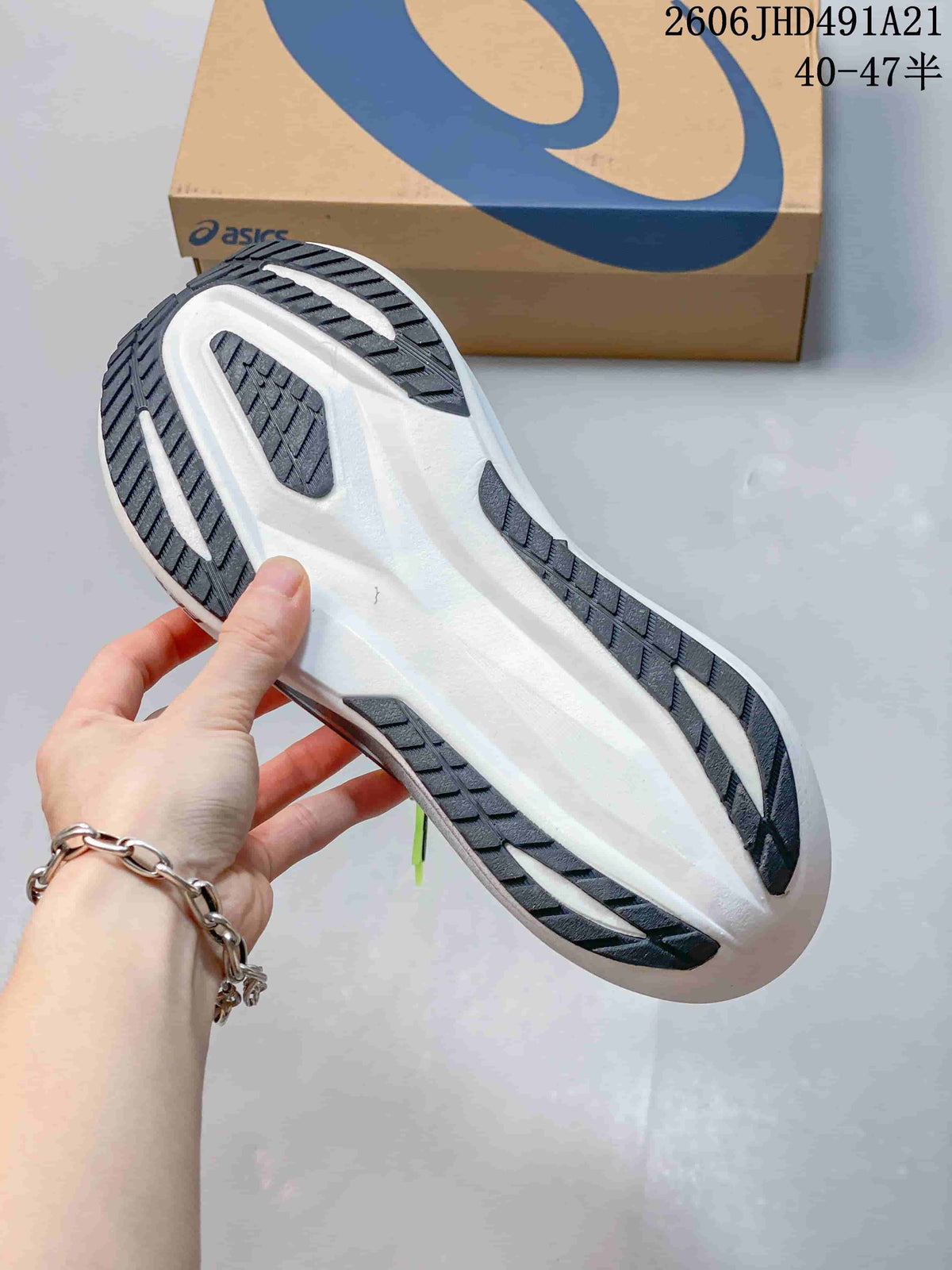 Underside of the running shoe showing a white midsole and dark outsole sections