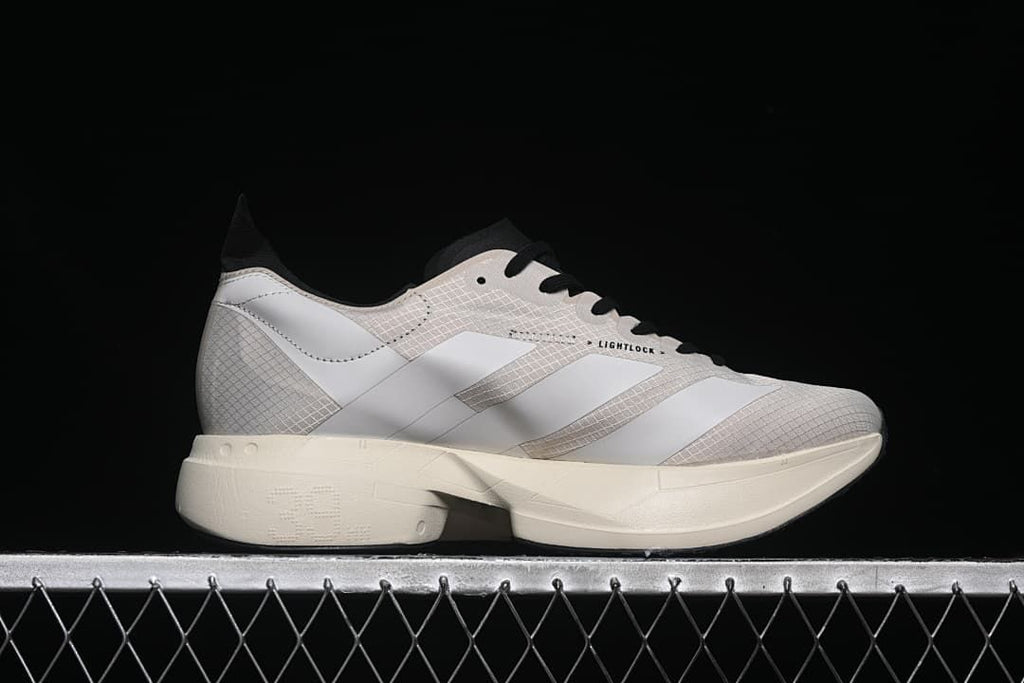 Side profile showing the patterned upper, three stripes and sculpted sole