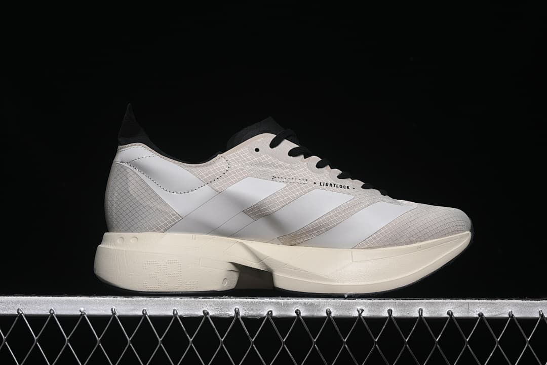 Side profile showing the patterned upper, three stripes and sculpted sole