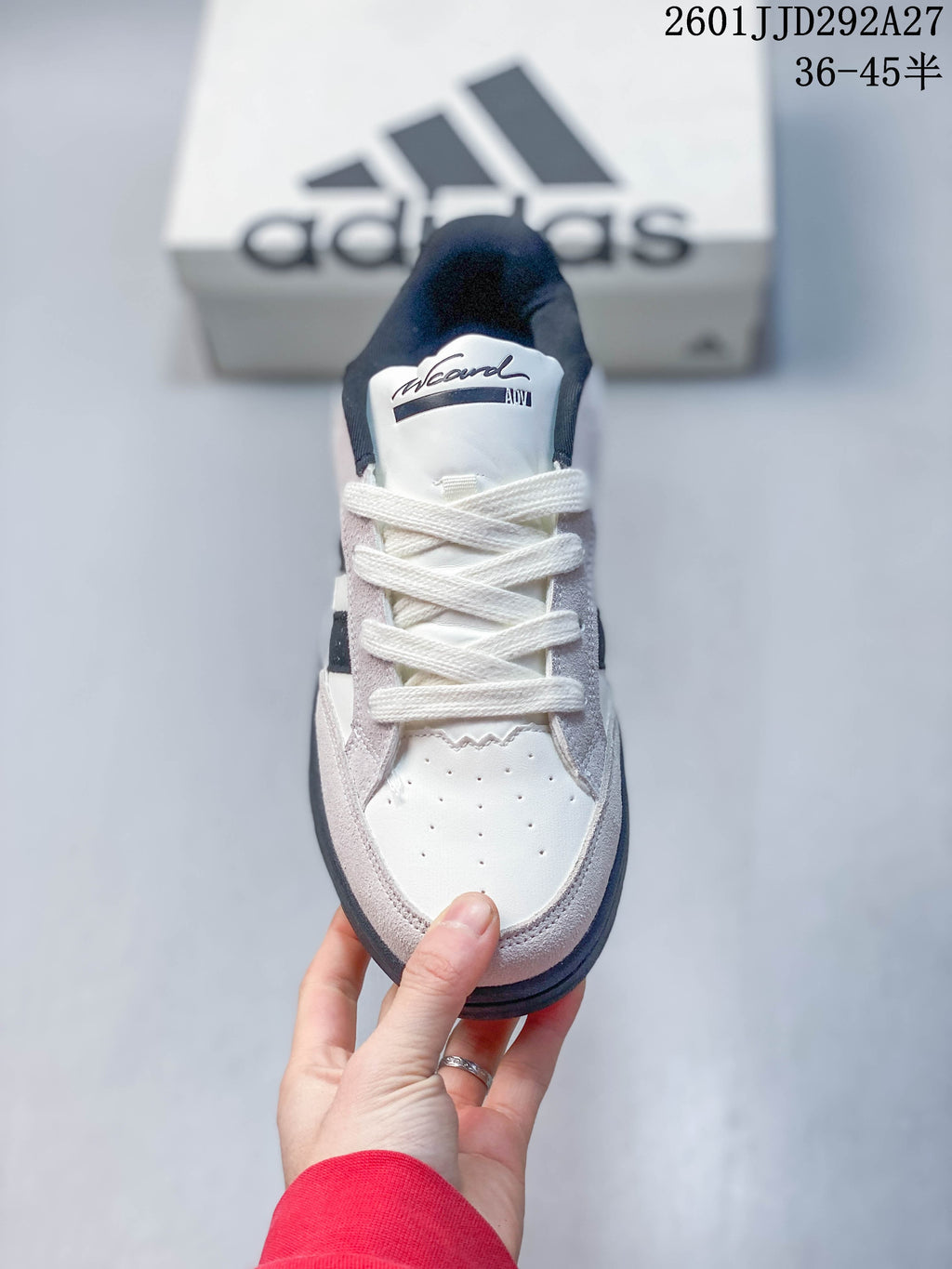 Front view of an Adidas Wcard Adv sneaker with white laces and a perforated toe panel